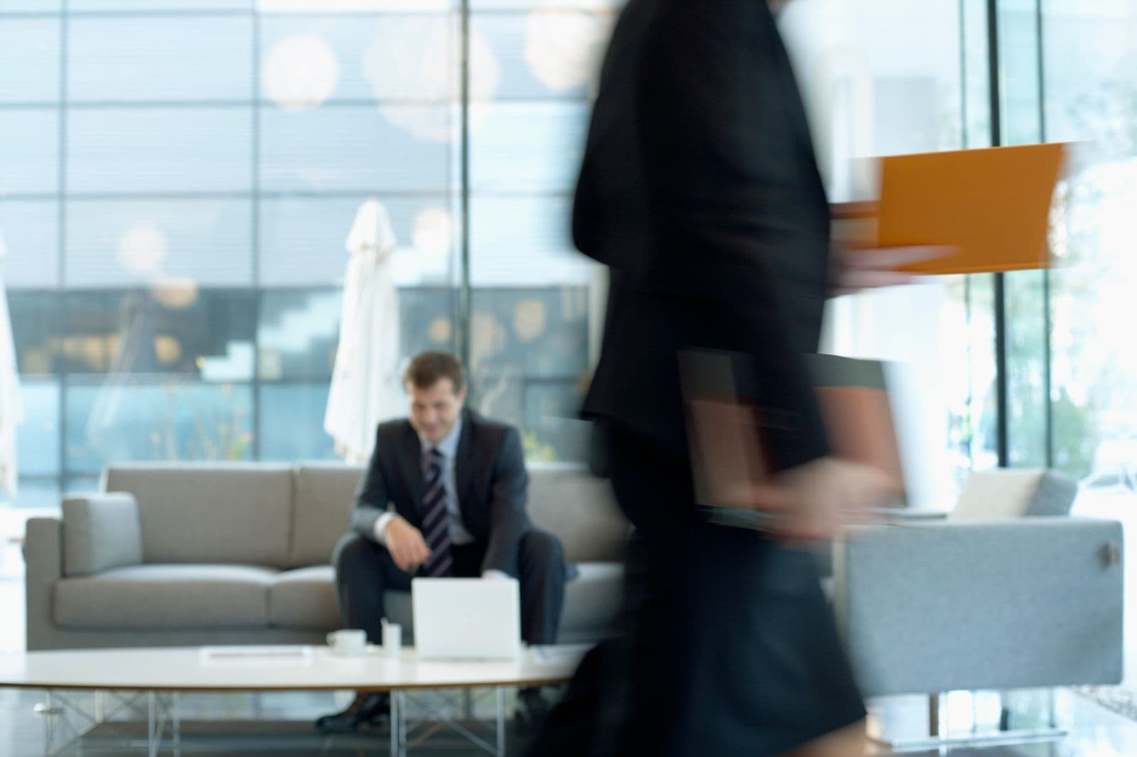 Person working on a laptop in a modern office lounge